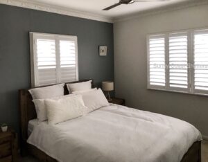 white hinged shutters in bedroom