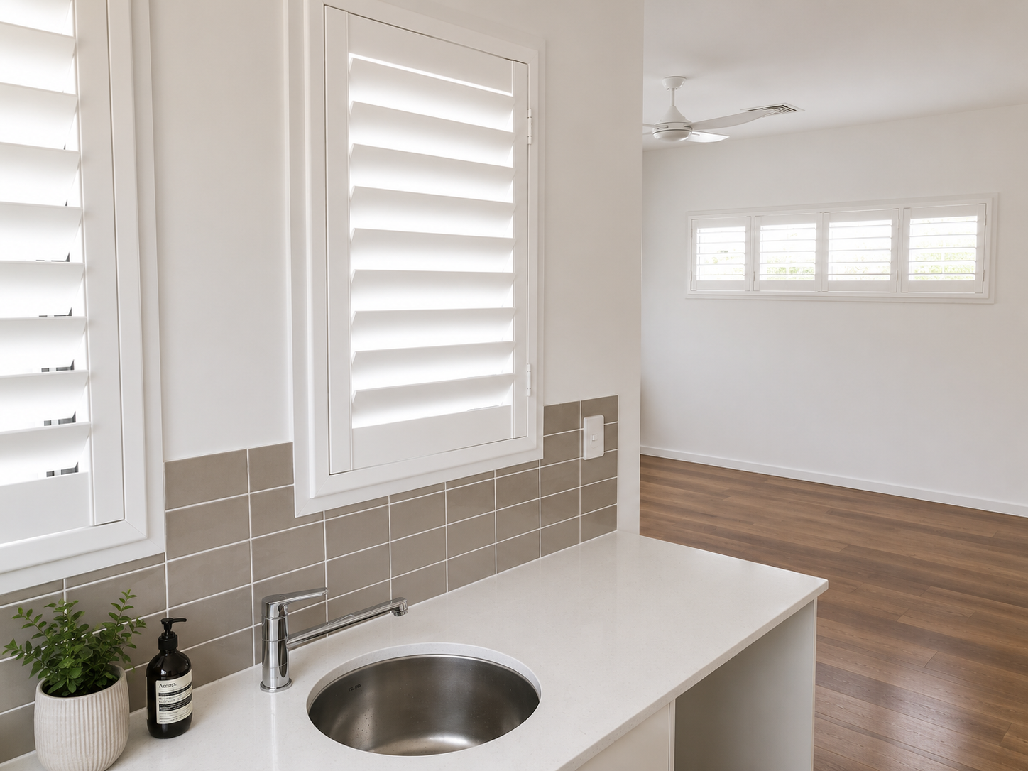 White shutter in new building over basin worktop 

