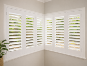 Corner window with white plantation shutters looking onto fence green garden 
